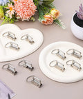 Top Shelf One Inch Silver Key Fob Hardware Bulk Pack With Smooth Split Rings And Heavy Duty Wristlet Clasps on white plates.