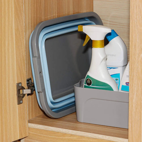 Two Pack Collapsible Sink With 2.25 Gallon Capacity Each Foldable Dish Tub stored in cabinet with cleaning supplies