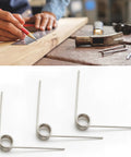 10 Pack Small Stainless Steel Torsion Springs 50mm Long 1.2mm Thick 11.4mm OD With 5 Turns And 120 Degree Rotation shown on a table