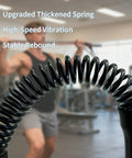 Close-up of coiled spring with person in gym using Two Pack Cordless Ropeless Battle Ropes For HIIT And Cardio in the background.