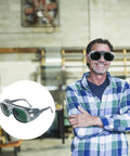 Man wearing Badass Welding Glasses With Anti Glare Black And Gray Lenses Rock Solid Safety Goggles in workshop.