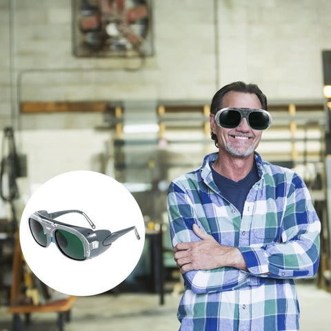 Man wearing Badass Welding Glasses With Anti Glare Black And Gray Lenses Rock Solid Safety Goggles in workshop.