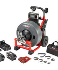 Heavy Hitting 3/4 Inch Cordless Drain Cleaning Drum Machine With Auto Feed And Cable Counter featuring accessories and charger.
