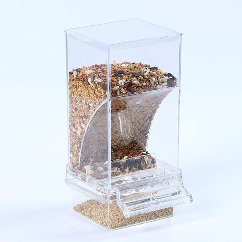 Top Tier No Mess Bird Feeder Set That Keeps The Cage Crisp Includes Cozy Perch And Crystal Clear Acrylic Hopper filled with bird seed.