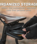 Cyclist accessing Elementa GearBag Under-Seat Bike Bag With Dual Compartments Quick Access Rail Wing System mounted on bike.