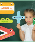 Child holding Five Animal Math Magnets For Classroom Teaching Kit Kid Friendly With Greater Than Less Than Plus Minus and Equal To Signs