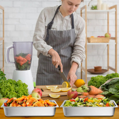 Person prepares food with 4 Pack Full Size Hotel Pans 1/1 Deep 4 Inch Heavy Duty Stainless Steel Food Pans filled with salad and vegetables
