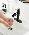 Oil Rubbed Bronze Waterfall Bathroom Faucet With Single Handle, 1 Or 3 Hole 4 Inch Install, person washing hands under faucet