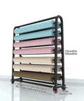 Heavy Duty Fabric Roll Storage Rack With Adjustable Hanging Rod And Movable Steel Organizer For Coils Wraps Craft Supplies in a workshop setup.