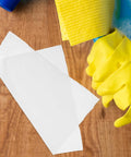 Person wearing yellow gloves cleaning wood with Anti-Static Microfiber Cleaning Cloths 22cm Pack Of 100 Dust Busting Rags.