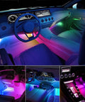 Lit Dream Color RGB-IC USB Interior LED Light Strips 12V DC Multicolor Footwell Under-Dash Kit With App Control And RF Remote Chasing Lights Music Sync Two-Line Setup For Cars Trucks ATVs UTVs illuminating car interior with vibrant colors.
