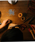 Glasses Repair Screws Kit, 100 Piece Eyeglass Screw Set For Glasses And Sunglasses on a workbench with tools and wires
