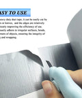 A person cutting heavy duty grey duct tape with scissors, showcasing easy use of 2 Pack Heavy Duty Duct Tape Waterproof And Heat Resistant With Tough As Nails Adhesive For HVAC Home Improvement Outdoor Use Packaging Boxes Pipe Insulation And Window Sealing 21 Yards By 2 Inches.