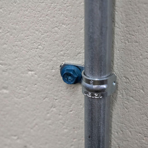 Installed Beefy Combo Pack Of Star Drive Hex Washer Head Masonry Screw with pipe, rust resistant, high strength for tough installations.