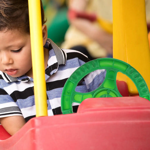 Child playing with Kids Steering Wheel Toy For Outdoor Playsets And Swings, Portable Plastic Accessory For Pretend Play And Backyard Fun.