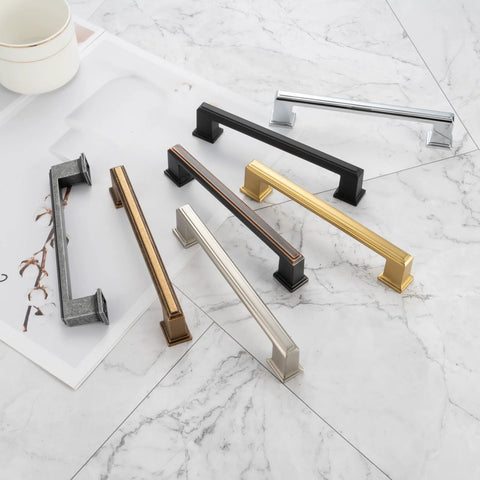 Assorted colored cabinet pulls on a marble surface, showcasing design and color variety, similar in size to 10 Pack 5 Inch Cabinet Pulls In Oil Rubbed Bronze For Kitchen Cabinets Cupboards Dresser Drawers Bedroom Wardrobes And Bathroom Furniture Hardware Solid Metal Handles With Smooth Rounded Edges For Easy Use And Elegant Finish.