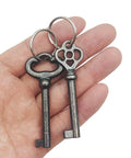 Heavy Duty Solid Brass Skeleton Keys With Antique Finish Plus Two Classic Barrel Designs And Durable Key Rings For Fixing Vintage Door Locks And Adding Dope Retro Decor To Your Home in a hand.
