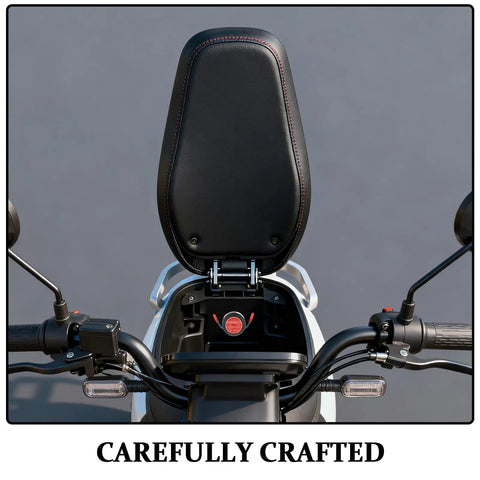Motorcycle seat with a black cushion and handlebar view, showcasing red stitching details and careful craftsmanship.