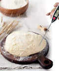 Digital Meat Thermometer Instant Read With Hold Function And Celsius Fahrenheit Switch in dough on wooden board