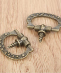 Mini Cabinet Knob Set Ten Pack Antique Bronze Finish With Self Tapping Screws on wood surface, showcasing zinc alloy design.