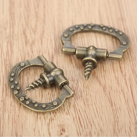 Mini Cabinet Knob Set Ten Pack Antique Bronze Finish With Self Tapping Screws on wood surface, showcasing zinc alloy design.