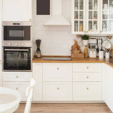 Gold Cabinet Knobs 10 Pack Brushed Brass Dresser Hardware on white kitchen cabinets with wooden countertop