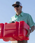 Man carrying portable 12 gallon marine gas can with built in fuel gauge and pick up cap 2 way vented cap easy to carry handles