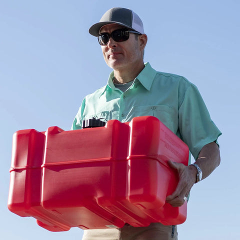 Man carrying portable 12 gallon marine gas can with built in fuel gauge and pick up cap 2 way vented cap easy to carry handles