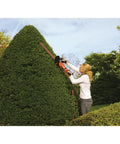 Person using Rotating-Handle Hedge Trimmer With 24-Inch Dual-Action Blades, 3.3-Amp Electric Shear, Cuts Up To 3/4-Inch Branches