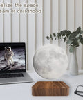 Levitating Moon Lamp With Magnetic Floating Spin next to laptop and vase in home office setup