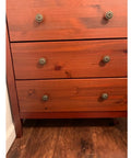 Flower Shape Metal Pull Knobs Set Of Four In Bronze Tone For Cabinets And Drawers With Screws Included Each Knob Measures About 1 Inch By 1.4 Inch No Fuss Rustic Hardware Upgrade For Kitchen Bath Or Office on a wooden dresser.