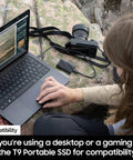 Person using laptop with T9 Portable SSD 2TB External Solid State Drive With USB 3 2 Gen 2x2 And Read Speeds Up To 2000MB Per Second nearby