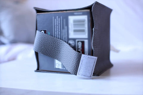 Tissue Box Cover Holder With Bottom Velcro Belt, Square PU Leather Organizer, shown on tabletop with Velcro belt detail