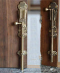Rugged Solid Brass Slide Bolt Gate Latch With Bulletproof Flip Mechanism For Knockout Garden Door Security Pro Grade Exterior Hardware Kit With Fasteners mounted on a wooden door.