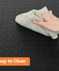 Person cleaning Heavy Duty Anti Fatigue Floor Mat 3 Feet By 6 Feet 15 To 16 Inch Thick Diamond Plate Memory Foam Ergonomic Standing Mat