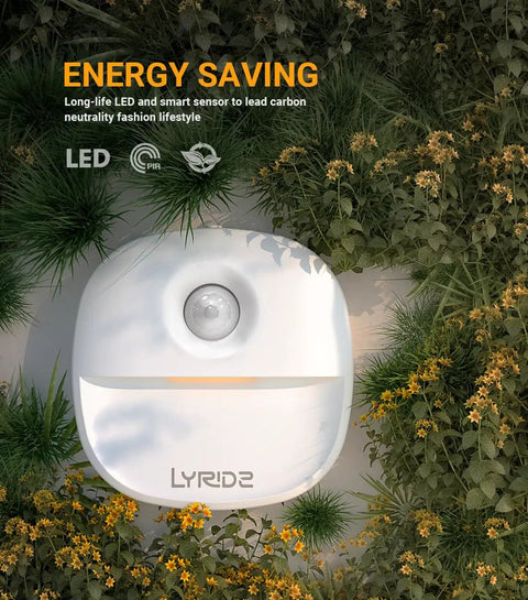Plug In Night Light With Motion Sensor And Dusk To Dawn Sensor Dimmable Warm Nightlight outdoors in grass, energy saving LED.