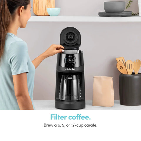 Woman using Brew Choice Pod And Carafe Coffee Maker For K Cup Pods Or Ground Coffee, 12 Cup Capacity, Auto Brew Sense Detects Pod Or Filter
