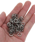 Heavy Duty Stainless Steel Split Lock Washers M6 in a hand, 300 Piece Top Shelf Rock Solid Spring Washer Set for workshop use.