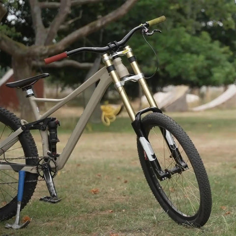 Beefy 26 Inch Mountain Bike Suspension Fork With 180 Mm Travel Magnesium Alloy Downhill Fork on a bike in a grassy park