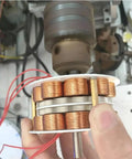 Close-up view of double layer iron core hydro generator component in a setup, featuring copper coils and rotor assembly.