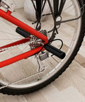 Close-up of a bike wheel with a Three Eighths Inch Aluminum Bike Pegs Set With 26 Teeth Anti Skid Foot Pedals For BMX MTB Road and Track Bikes.