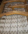 Heavy Duty 9 Gauge Zig Zag Sinuous Springs For Furniture And Auto Upholstery 10 Foot Roll installed in wooden frame.