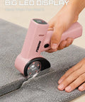 Punomo Cordless Electric Box Cutter With Rechargeable All Copper Motor cutting gray carpet, showcasing LED display and ergonomic handle.