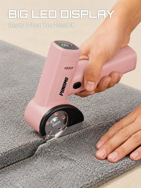 Punomo Cordless Electric Box Cutter With Rechargeable All Copper Motor cutting gray carpet, showcasing LED display and ergonomic handle.