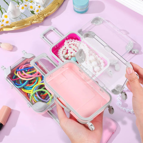 Front view of clear plastic mini suitcase party favor box with pink interior and wheels (4-pack)
