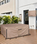Heavy Duty Rectangular Patio Table Cover For 111 Inch Long By 74 Inch Wide Table With 6 To 8 Chairs, 600D Canvas Waterproof Outdoor Furniture Cover, All Weather Protection For Rain Sun And Dust on a patio.