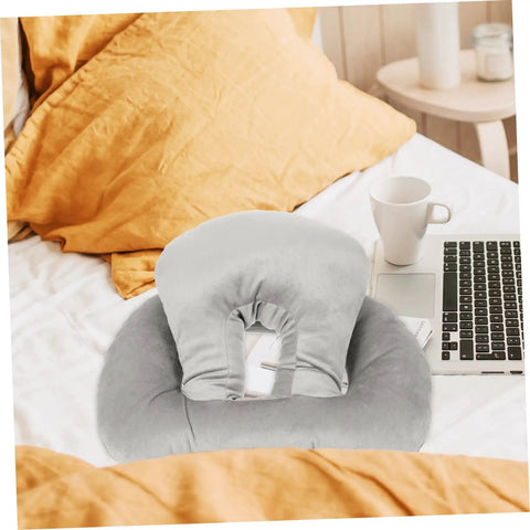 Portable Ergonomic Nap Pillow For Office And School, Face Down Sleep Cushion In Gray on bed with laptop and cup