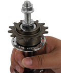 Close-up of a hand holding a Universal 36 Hole Rear Bike Hub With Solid Axle And 14T for BMX and MTB, showing metal construction and gear teeth.