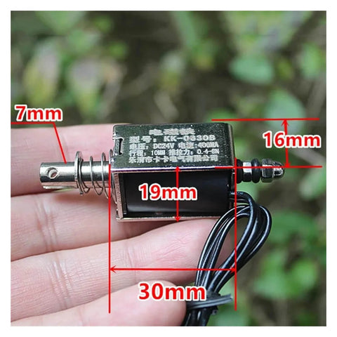 Hand holding 24V Linear Push Pull Solenoid Electromagnet Open Frame Rugged Workhorse Actuator With 10mm Stroke Plunger for automation