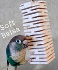 Safe Untreated Ultra Soft Balsa Wood Foraging Toy With Canyon Groove Design For Small Parrots Enrichment Interactive Destructible Chew Toy With Stainless Steel Hook For Green Cheek Conures Cockatiels next to a conure.